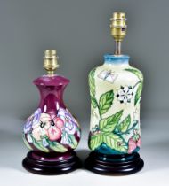 Two Moorcroft Pottery Table Lamps on Wooden Bases, one decorated with "Fruit Garden" design on a