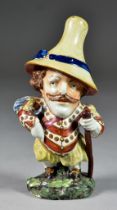 An English Pearlware Mansion House Dwarf, Circa 1820, with richly painted costume and high yellow