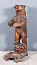 A Late 19th Century Black Forest Carved Bear Umbrella Stand, the naturalistically carved bear with