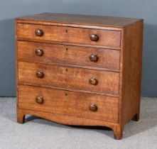 A George III Oak Chest, with square edge to top, fitted four long graduated drawers, on shaped apron