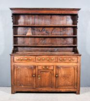 An 18th Century Oak Dresser, the upper part with moulded cornice, fitted three shelves, the base