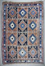 A 20th Century Yalameh Carpet woven in colours of fawn, pale blue and terracotta, with twelve hooked