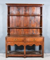 An Old Oak Dresser, the upper part with moulded cornice and open shelves, the base fitted two frieze