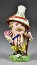 A Derby Porcelain Mansion House Dwarf, Circa 1810, the corpulent figure wearing a bright costume