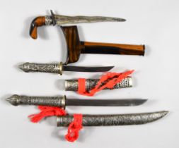 Three Far Eastern Edged Weapons, comprising - two cased and highly decorated silvery metal, 13ins