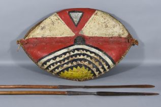 A Masai Shield, Kenya/Tanzania, 20th Century, of wood and cowhide construction, painted with organic
