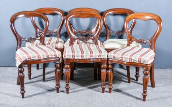 A Set of Six Victorian Mahogany Balloon Back Dining Chairs, with plain crest rails and carved
