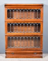 A Globe Wernicke Oak Three Tier Sectional Bookcase, each section enclosed by a leaded glazed