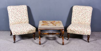 A Pair of Victorian Low Nursing Chairs, upholstered in floral pattern cloth, on turned and fluted