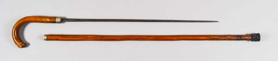 A Sword Stick, Early 20th Century, 21ins double edged blade, hardwood handle and scabbard, 34.