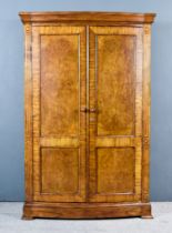 A Modern Burr and Cross Banded Walnut and Oak Wardrobe by Frank Hudson, with moulded edge to top,