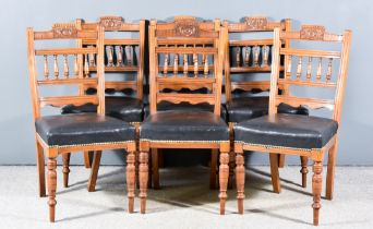 A Set of Six Victorian Walnut Dining Chairs, with shaped floral and leaf carved crest rails, spindle