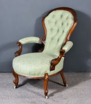 A Victorian Walnut Framed Spoon Back Open Armchair, the moulded frame with leaf scroll carving,
