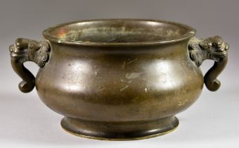 A Chinese Bronze Circular Two-Handled Censer,  with lion dog and scroll handles to the bulbous