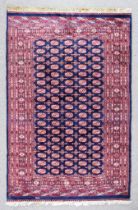 A 20th Century Indian Bokhara Carpet of Turkmen Design, woven in colours of navy blue, ivory and