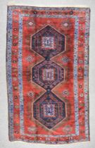 An Early 20th Century Kazak Carpet, woven in colours of navy blue, pale blue and wine, with three