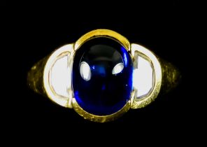An 18ct Gold Cabochon Sapphire and Diamond Ring, set with a centre cabochon sapphire,