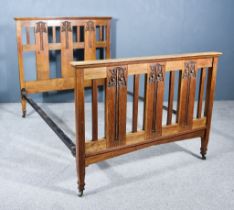 An Early 20th Century Oak Bedstead, of Arts & Crafts Design, the head and foot board carved with