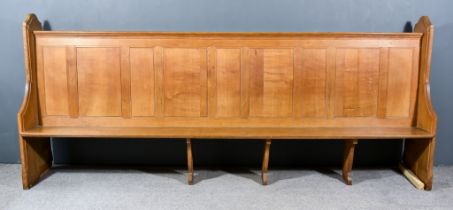 A Large Victorian Oak Pew, with heavy shaped and moulded end supports, panelled back and plain