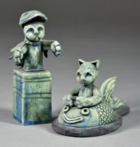 Sally MacDonell (b.1971) - Two porcelain figures of cats, one hooded, the other 'steering' a fish