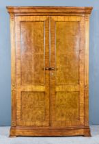 A Modern Burr and Cross Banded Walnut and Oak Wardrobe by Frank Hudson, with moulded edge to top,