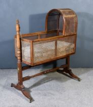 A 19th Century Mahogany Cradle, with cane panels, on twin turned supports and stretchers, brass