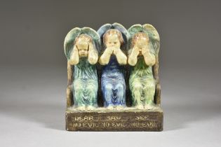 A Compton Pottery Bookend, Early 20th Century, modelled as three angels - "Hear No Evil, Say No