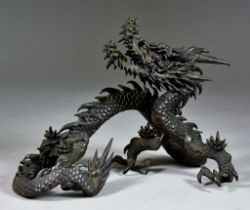 A Chinese Bronze Model of a Four-Clawed Dragon Amongst Clouds, Modern, 6.5ins (16.5cm) high