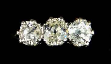 An 18ct White Gold Three Stone Diamond Ring, set with a centre brilliant cut white diamond,