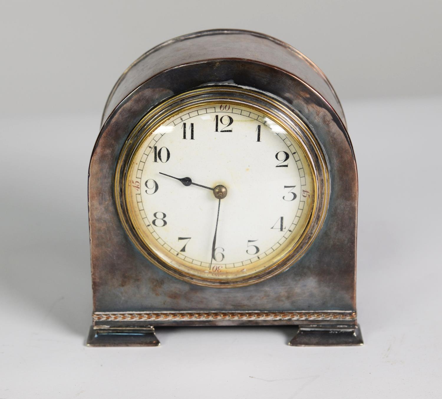 EARLY 20th CENTURY SMALL MANTEL CLOCK IN PLANISHED ELECTRO-PLATED CASE with white Arabic dial