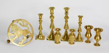 BRASS WARES- TWO GRADUATED PAIRS OF BRASS EJECTOR CANDLESTICKS, 8 ¾” and 7” (22.2cm and 17.8cm)