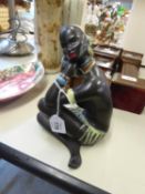 CIRCA 1960's WEST GERMAN EARTHENWARE FIGURE OF A SEMI NAKED AFRICAN NATIVE GIRL, SEATED CROSS LEGGED