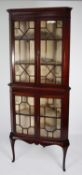 EDWARDIAN LINE INLAID MAHOGANY DOUBLE CORNER CUPBOARD enclosed by four astragal glazed doors, on