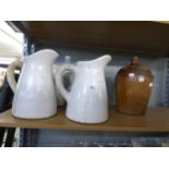 FOUR HEAVILY POTTED TIN GLAZED WATER EWERS AND A STONE FLAGON (5)