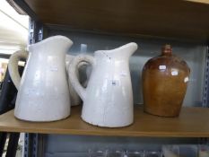 FOUR HEAVILY POTTED TIN GLAZED WATER EWERS AND A STONE FLAGON (5)