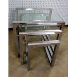 A NEST OF THREE BRIGHT STEEL CONTINUOUS FRAMED OBLONG COFFEE TABLES, WITH GLASS TOPS