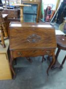 A MAHOGANY SMALL BUREAU WITH ONE LONG DRAWER, ON SLENDER CABRIOLE FRONT SUPPORTS, CARVED DETAIL TO