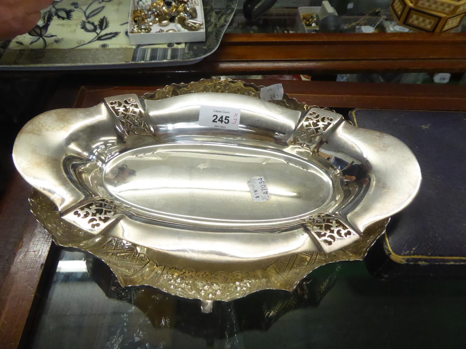 AN EP OVAL FRUIT BOWL, THE FLUTED SIDES REPOUSSE WITH ALTERNATE DIAPER AND FLORAL PANELS AND