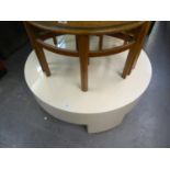 A CREAM PLASTIC COVERED LARGE CIRCULAR COFFEE TABLE, DRUM SHAPED