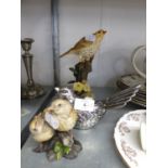 A SILVERED FINISH MODEL OF A BIRD; A RESIN GROUP OF TWO FLEDGLINGS; A RESIN MODEL OF A THRUSH IN A