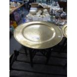 ORIENTAL BRASS TRAY TOP FOLDING TABLE WITH INCISED DECORATION IN THE FORM OF DRAGONS IN PURSUIT OF