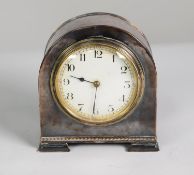 EARLY 20th CENTURY SMALL MANTEL CLOCK IN PLANISHED ELECTRO-PLATED CASE with white Arabic dial