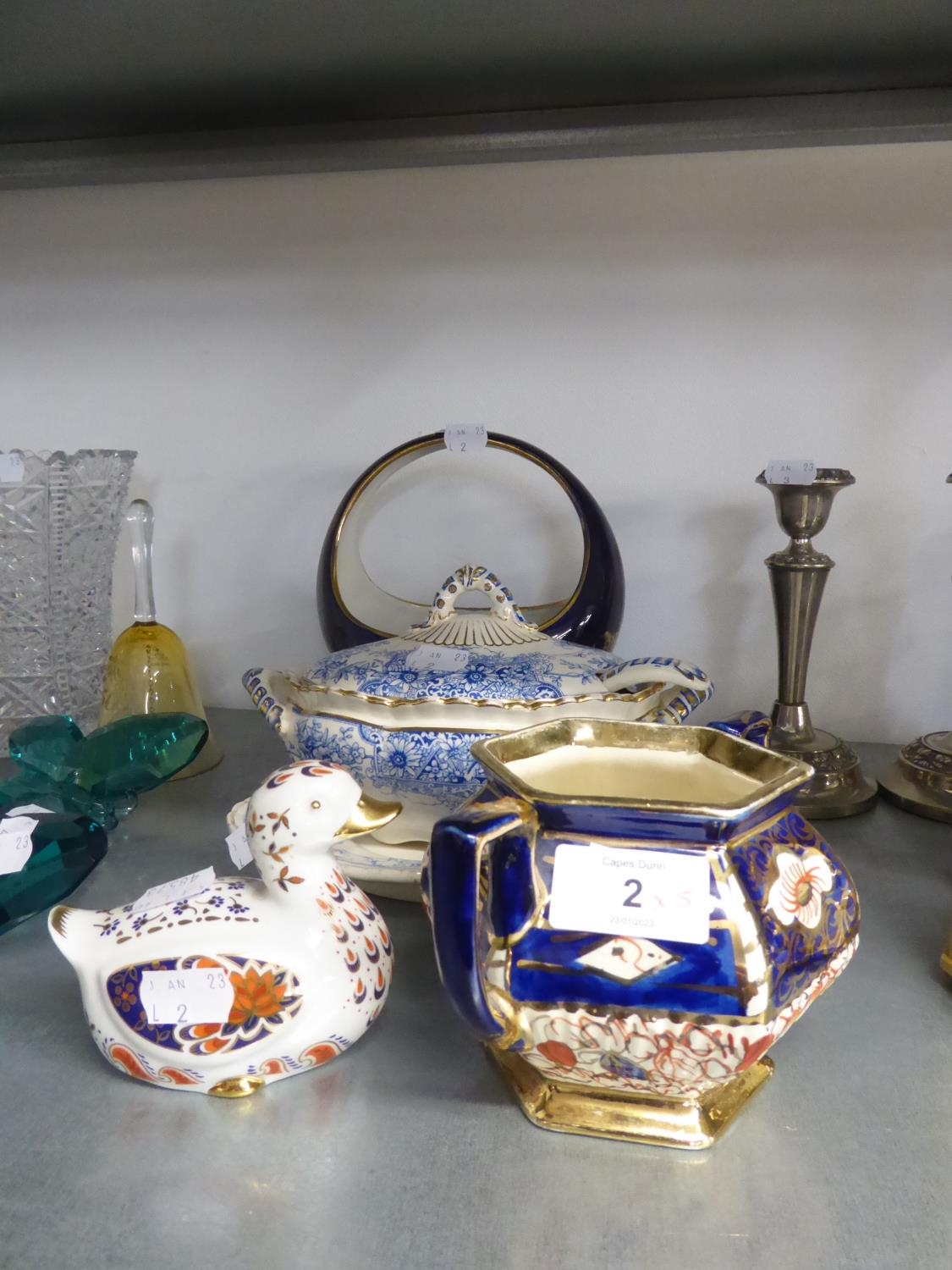 A CONTINENTAL CHINA BOWL WITH HOOP HANDLE; IMARI DECORATED CHINA DUCK; BLUE AND WHITE POTTERY TWO