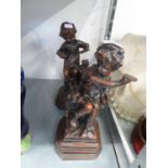A PAIR OF BRONZED RESIN FIGURES, EACH OF A SEATED CHILD AND A DOG (2)