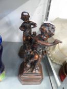 A PAIR OF BRONZED RESIN FIGURES, EACH OF A SEATED CHILD AND A DOG (2)