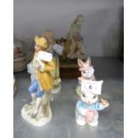 A RESIN GROUP OF A LADY AND CHILD WITH WHEEL, ON WOODEN BASE; A PAIR OF TINTED BISQUE FIGURES; A