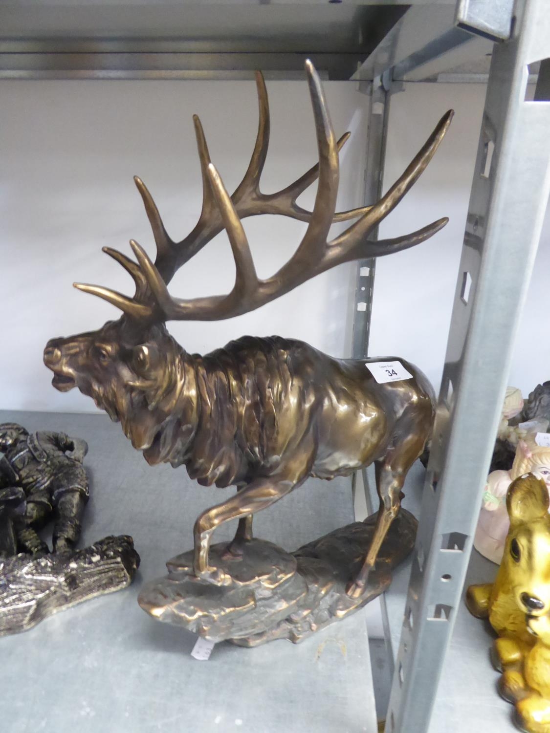 A BRONZE EFFECT MODEL OF A STAG, ON ROCKY BASE, 18” HIGH