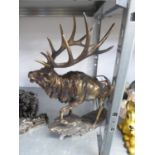 A BRONZE EFFECT MODEL OF A STAG, ON ROCKY BASE, 18” HIGH