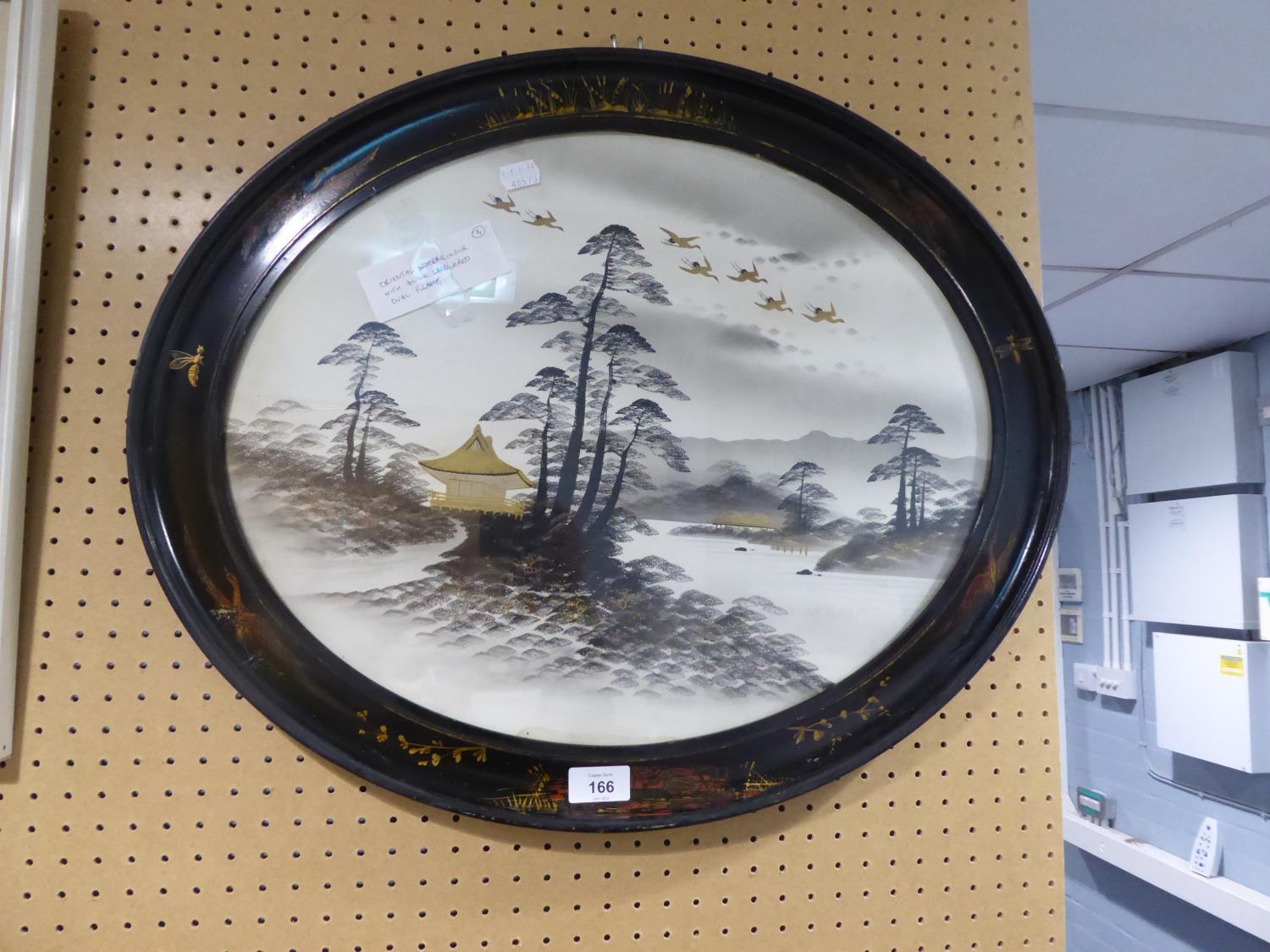 AN ORIENTAL WATERCOLOUR DRAWING, ‘ISLANDS’, IN DECORATED BLACK LACQUERED OVAL FRAME
