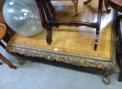 A MODERN LARGE SQUARE WALNUT COFFEE TABLE WITH CARVED FRIEZE AND LEGS